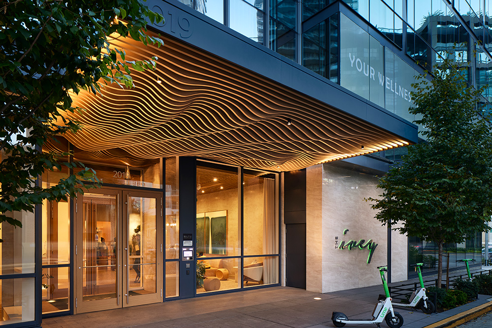 photo of the entrance at the ivey at night with an artistic wavy canopy