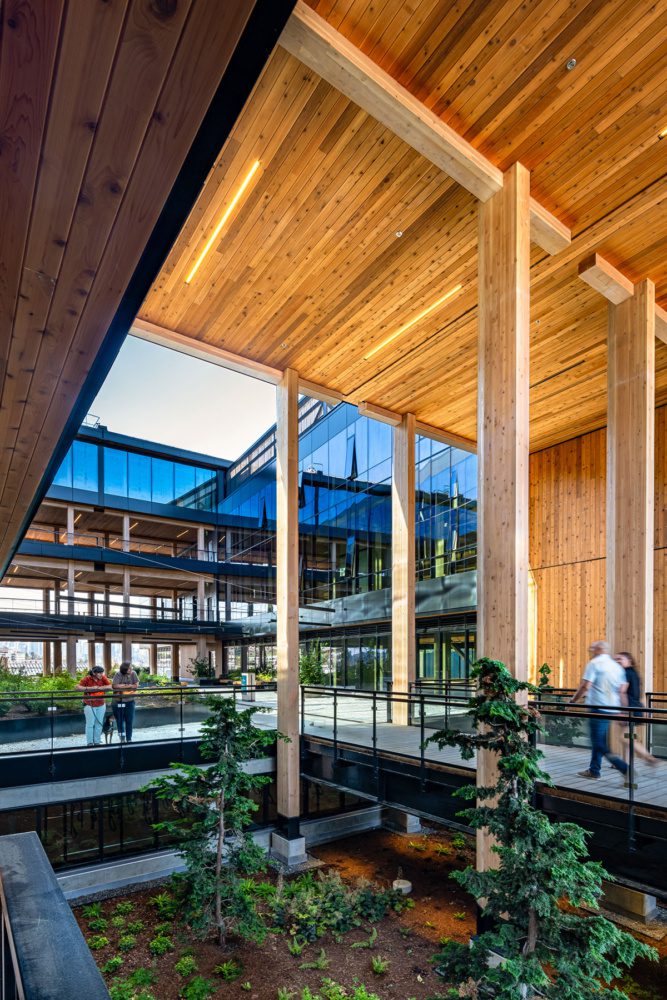 Exterior photo of the plaza at northlake commons with towering mass timber beams and people walking through the courtyard