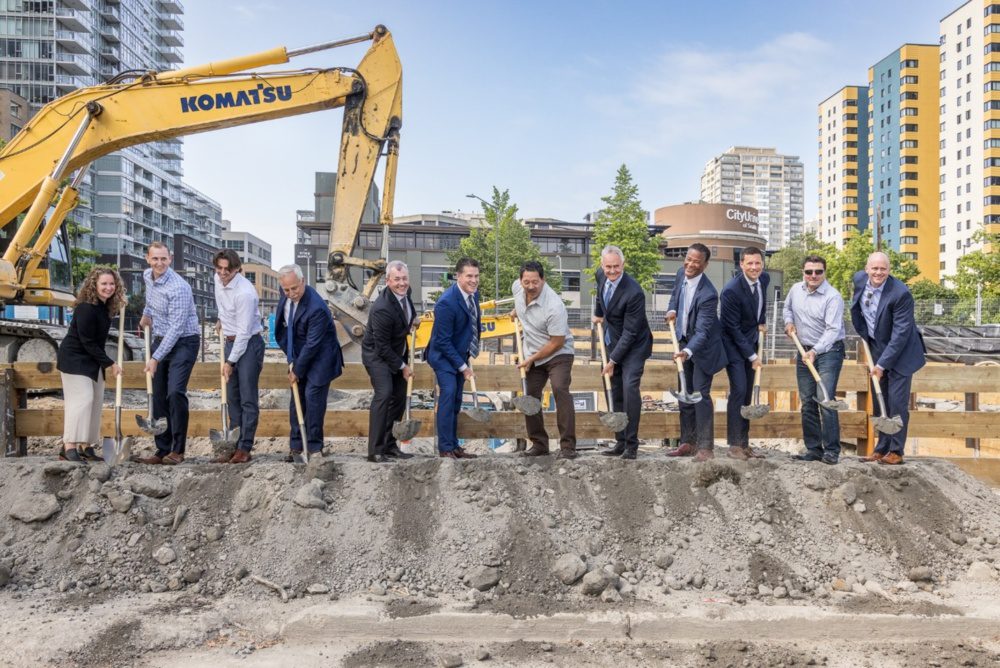 Photo at the sloane groundbreaking in downtown seattle. multiple people including seattle mayor bruce harrell digging into a pile of dirt