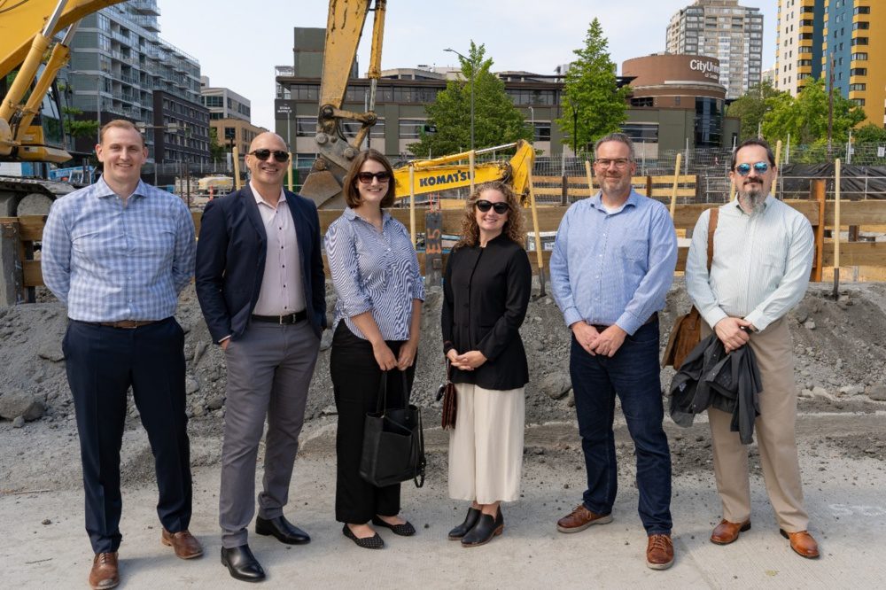 Photo of weber thompson sloane high-rise team members standing in front of the ceremonial dirt pile