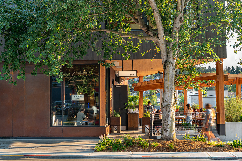 photo of the exterior of cedar speedster and the revel restaurant patio in fremont seattle during the daytime