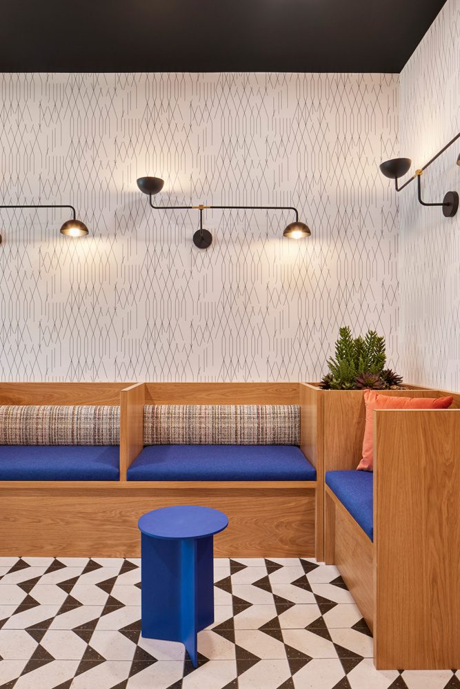 photo of the lobby at chronicle with black and white patterned tile and blue accents on the seating area