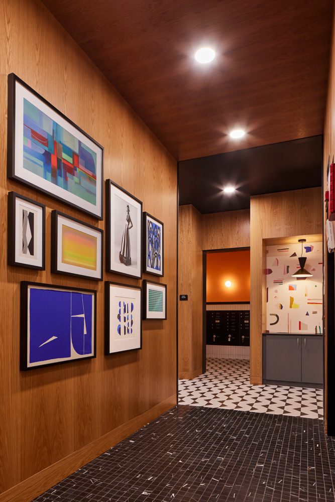 photo of a communal kitchen area at the chronicle with a fun pattern wallpaper surrounded by warm wood